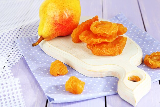 Dried pears on wooden background