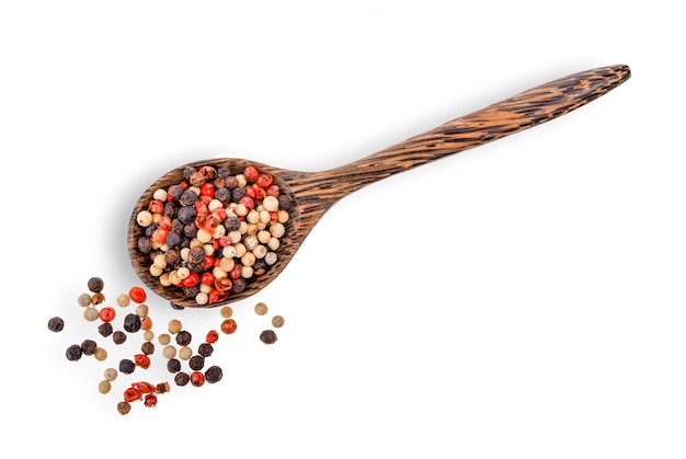 Dried peppers in wood spoon isolated 