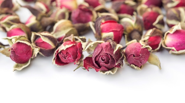 Dried pink rose on a white background.