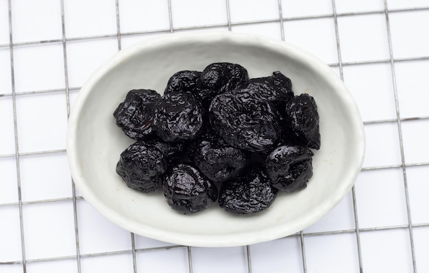 Dried prunes on white background