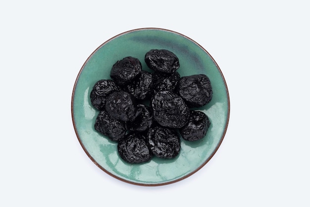 Dried prunes on white background