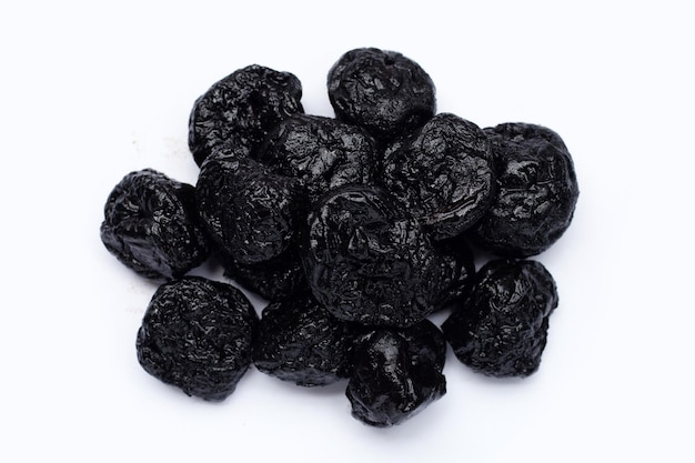 Dried prunes on white background