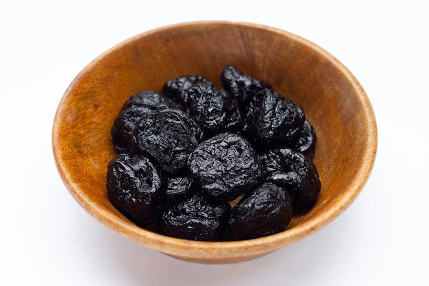 Dried prunes on white background