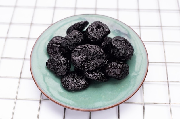 Dried prunes on white background