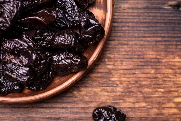 Dried prunes on a wooden background. Dry fruits.