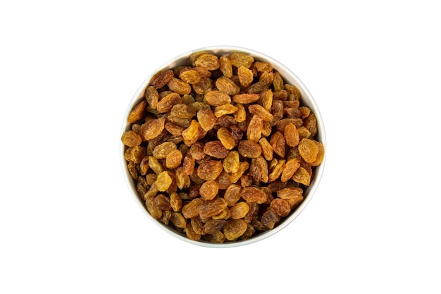 Dried raisins in a bowl on a white surface