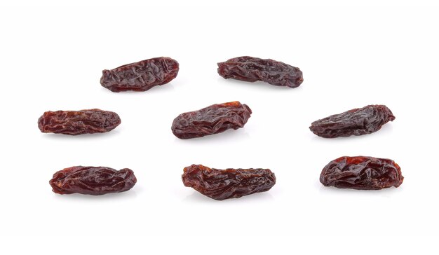 Dried raisins isolated on white surface.