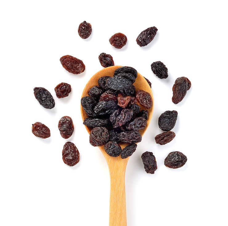 Photo dried raisins on white background.