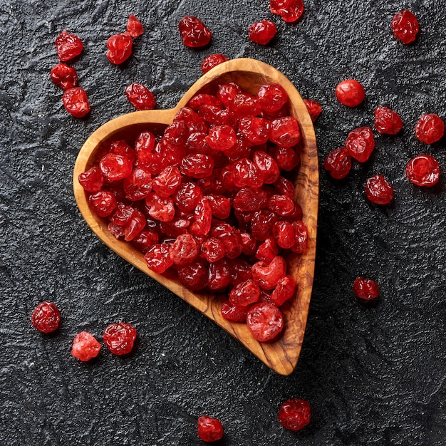 Dried red cherries on a black background