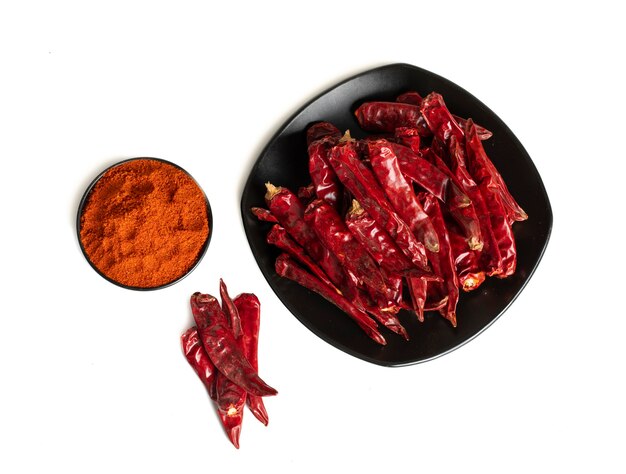 Dried Red Chili Peppers with Chili Powder on White Background