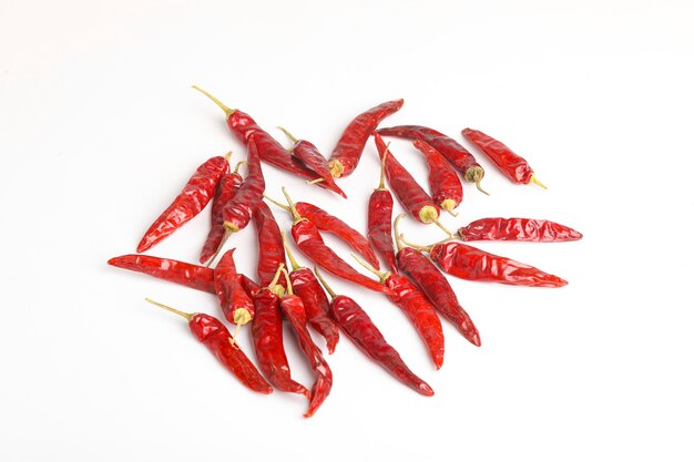 Dried red chilli on white surface