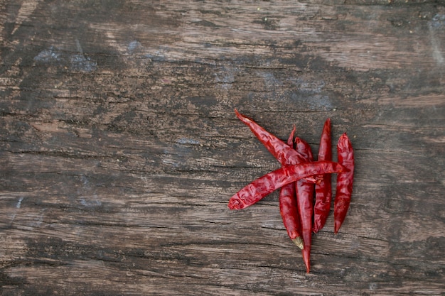 Dried red chilly pepper on wooden panel