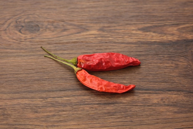 Dried red hot chili on wooden table copy space