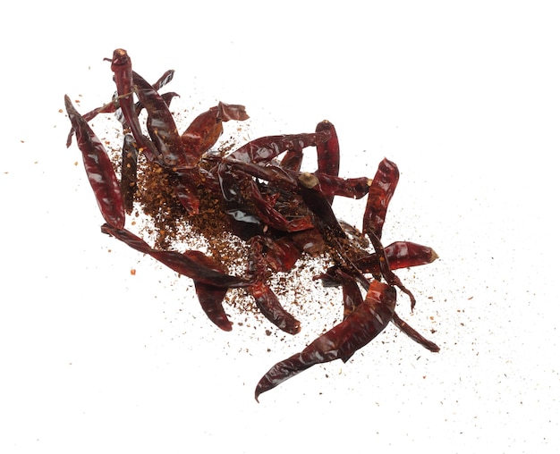 Dried Red hot Chilli fall down explosion dried Red Chilli float explode abstract cloud fly Mix ground powder Chillis splash throwing in Air White background Isolated high speed shutter freeze