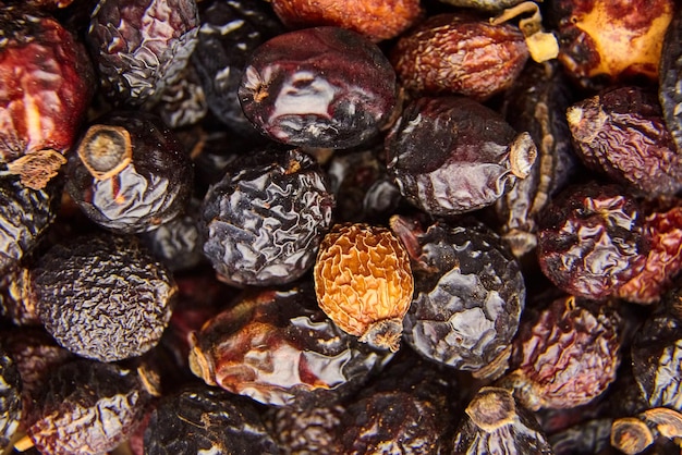 Dried rose hip fruits for herbal tea food background top view