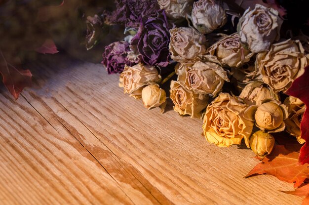 Dried roses on wood with copy space