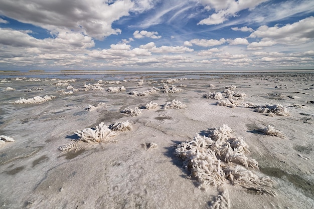 Dried salt lake layer of salt blue sky and clouds