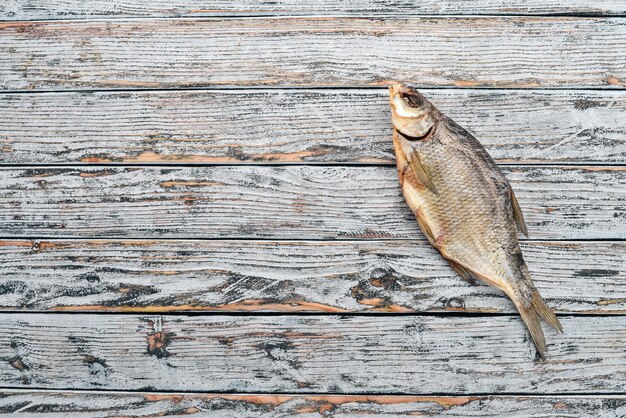 乾燥した塩漬けの魚ビール用スナックタランカ木製の背景にテキスト用の空きスペース上面図