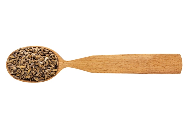 Dried silybum in a wooden spoon on a white background.