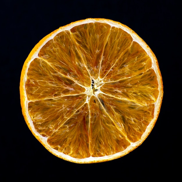 Dried slice of orange on a dark 
