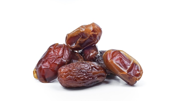 Dried sliced date fruit on white background with copy space Snack vegan sugarfree food