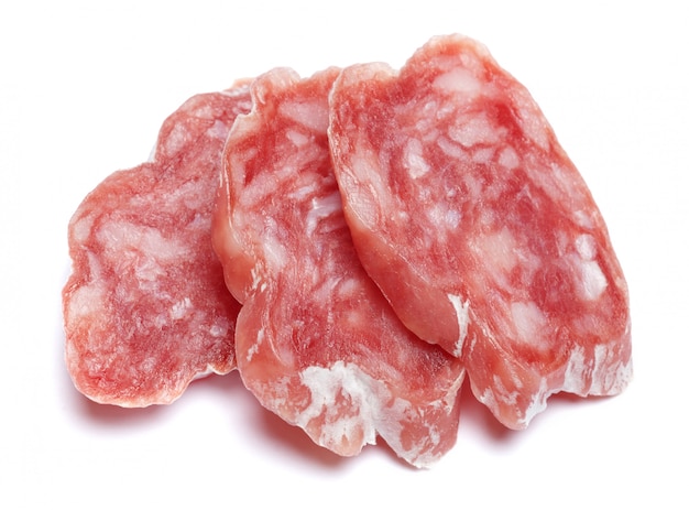 Dried sliced organic salami sausage on white isolated