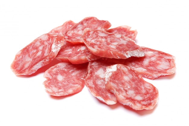 Dried sliced organic salami sausage on white isolated