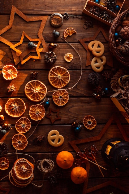 Dried slices of oranges cut into circles lie on a wooden table. New Year's Flatley.