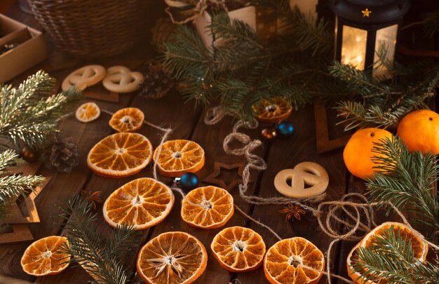 Dried slices of oranges cut into circles lie on a wooden table. New Year's Flatley