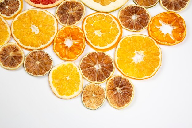 Dried slices of various citrus fruits on white background