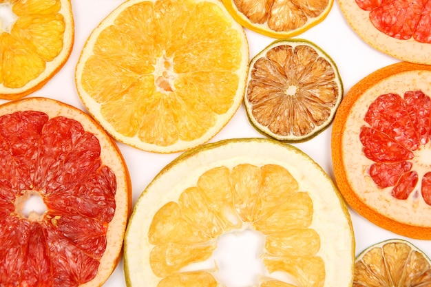 Dried slices of various citrus fruits on white background