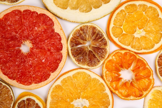 Dried slices of various citrus fruits on white background