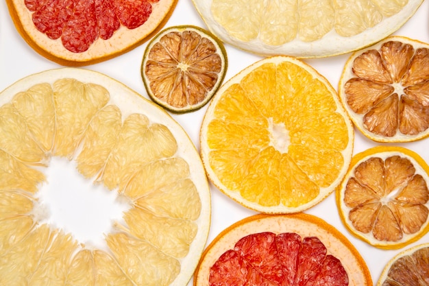 Dried slices of various citrus fruits on white