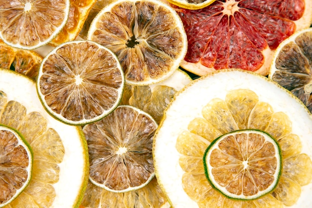 Dried slices of various citrus fruits on white
