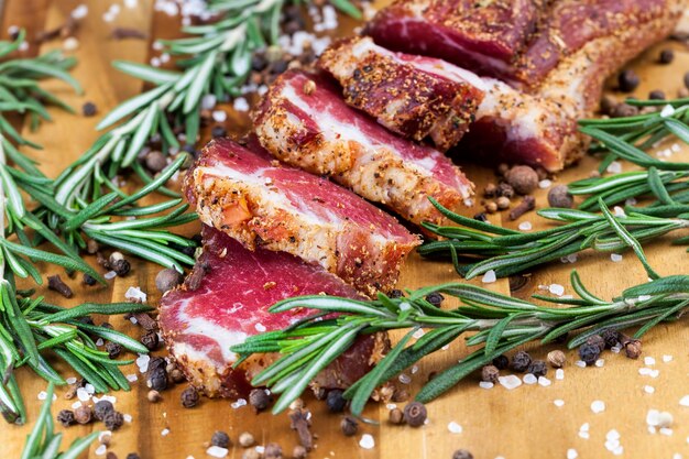 Dried and spiced meat sliced on a wooden board