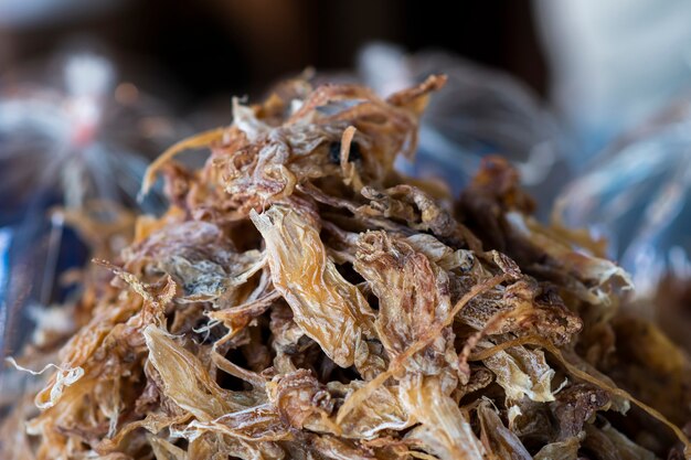 Dried Squid Tentacles one of the dried seafood dishes, lined up on a tray and blurred the background