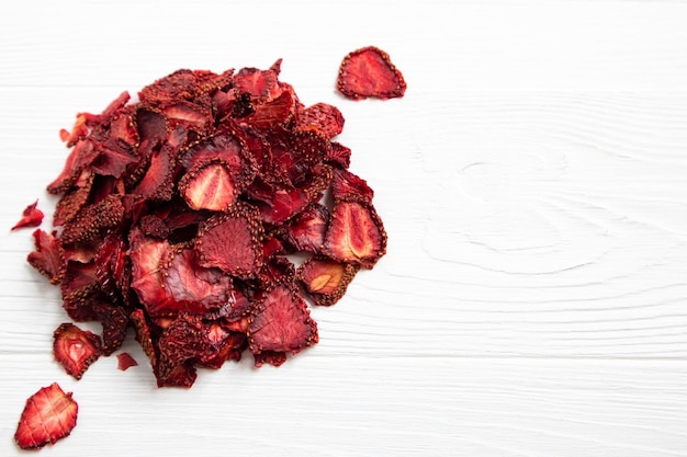 Dried strawberries on a white background with a place for text Preparations for a pleasant and healthy tea party