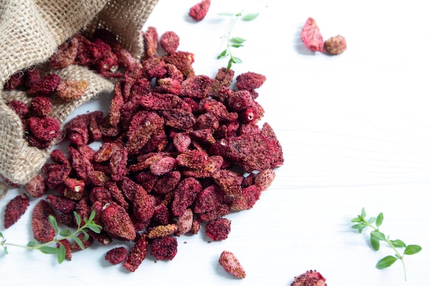 Dried strawberries on a white background with a place for text Preparations for a pleasant and healthy tea party