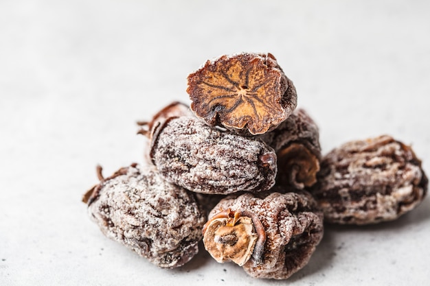 Dried sweet persimmon on a white background, copy space.