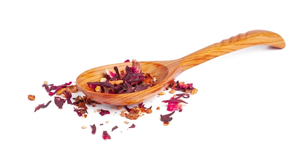 Dried tea on a wooden spoon, isolated on white