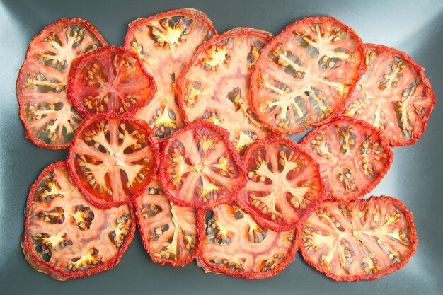 Dried tomato slices on a plate. Vitamin vegetable food