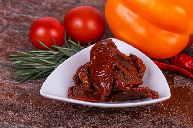 Dried tomatoes in the bowl with olive oil