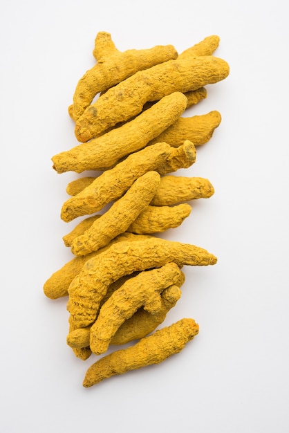 Dried Turmeric Roots or sookhi Haldi as a whole on white surface, selective focus