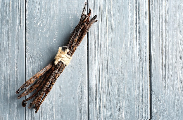 Dried vanilla sticks on wooden background