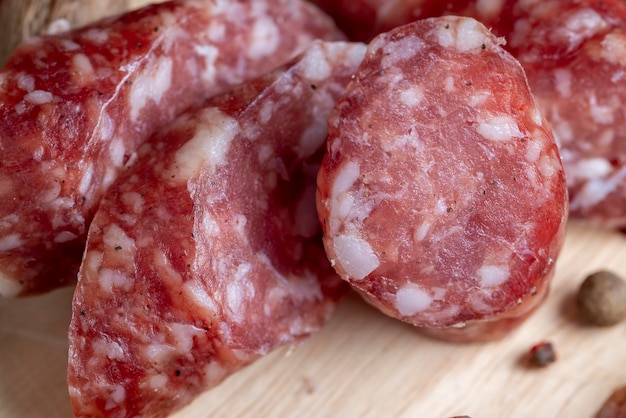 Dried veal sausage during slicing preparation of snacks from dried veal sausage