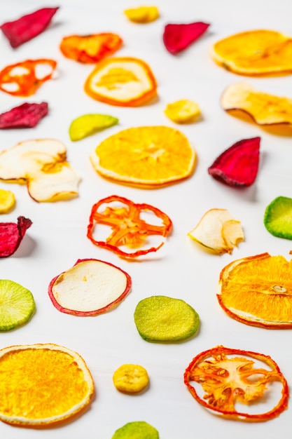 Dried vegetables and fruits on a white background.