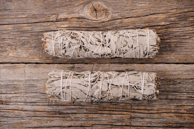 Dried white sage smudge bundles on table