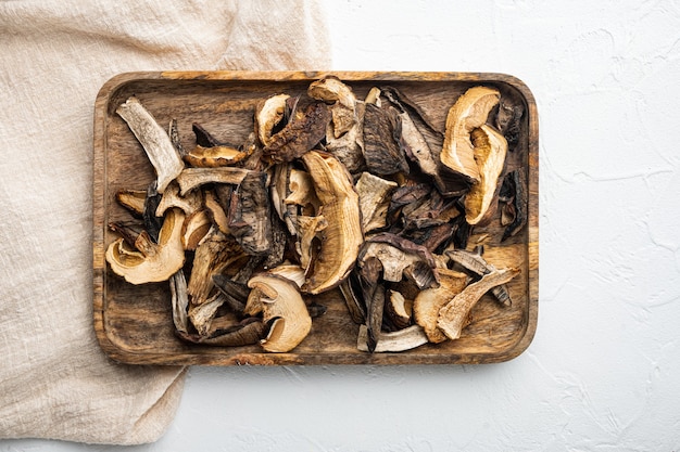 Dried wild mushrooms set, on white background, top view flat lay