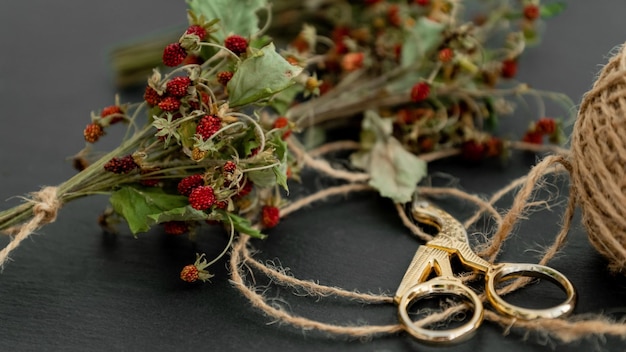 Dried wild strawberry twigs with berries tied in small bunch with rough twine Herbal medicine remedy