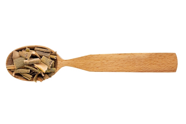 Dried willow bark in a wooden spoon on a white background. Phytotherapy and disease prevention.